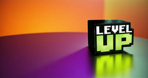 Black box with 'LEVEL UP' text on a gradient orange to purple background